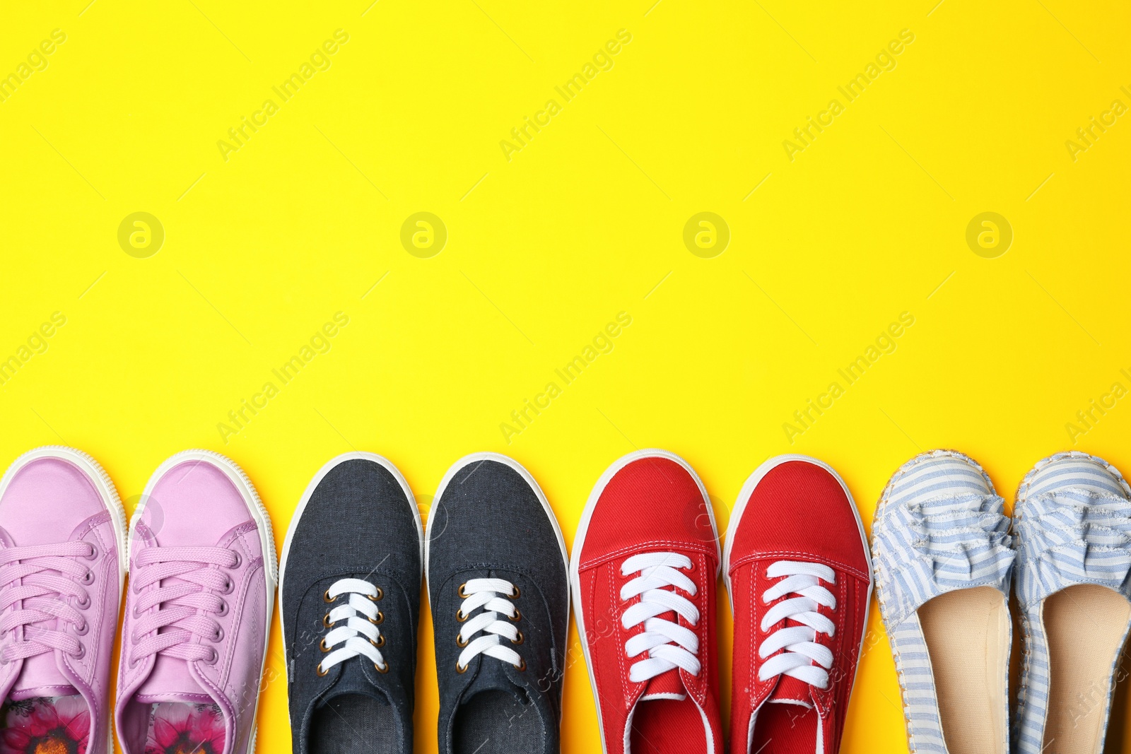 Photo of Flat lay composition with stylish new shoes on color background