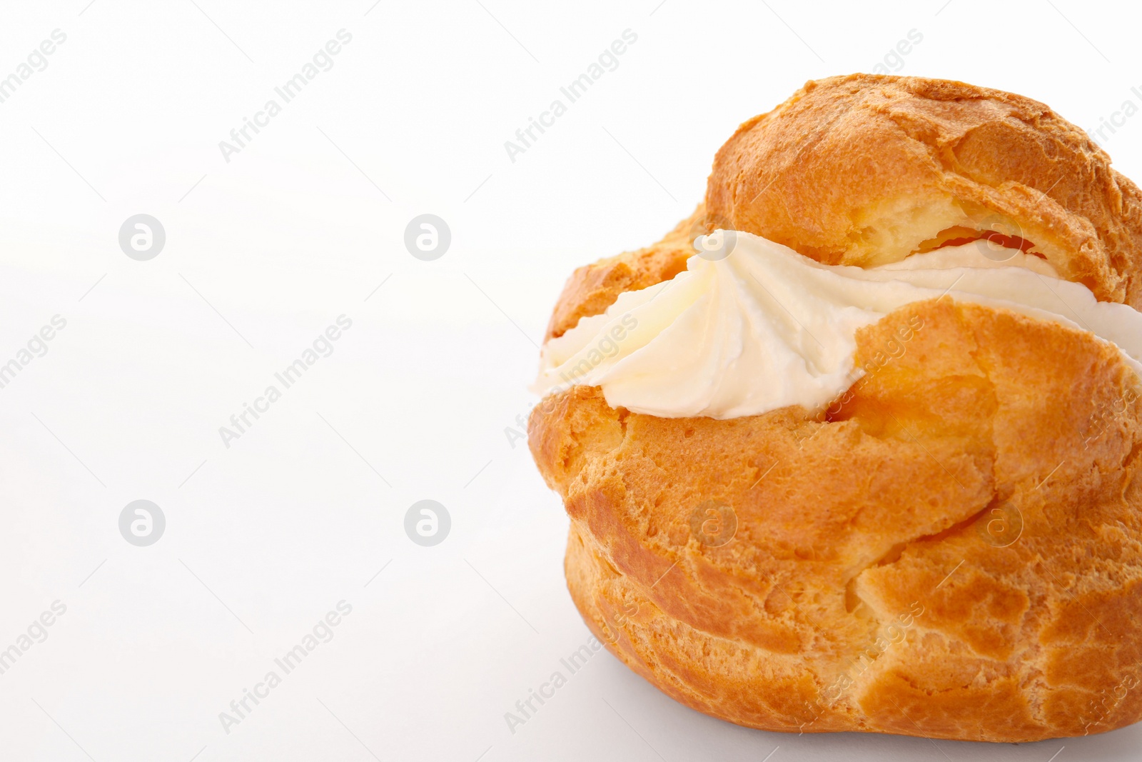 Photo of Delicious profiterole with cream filling isolated on white