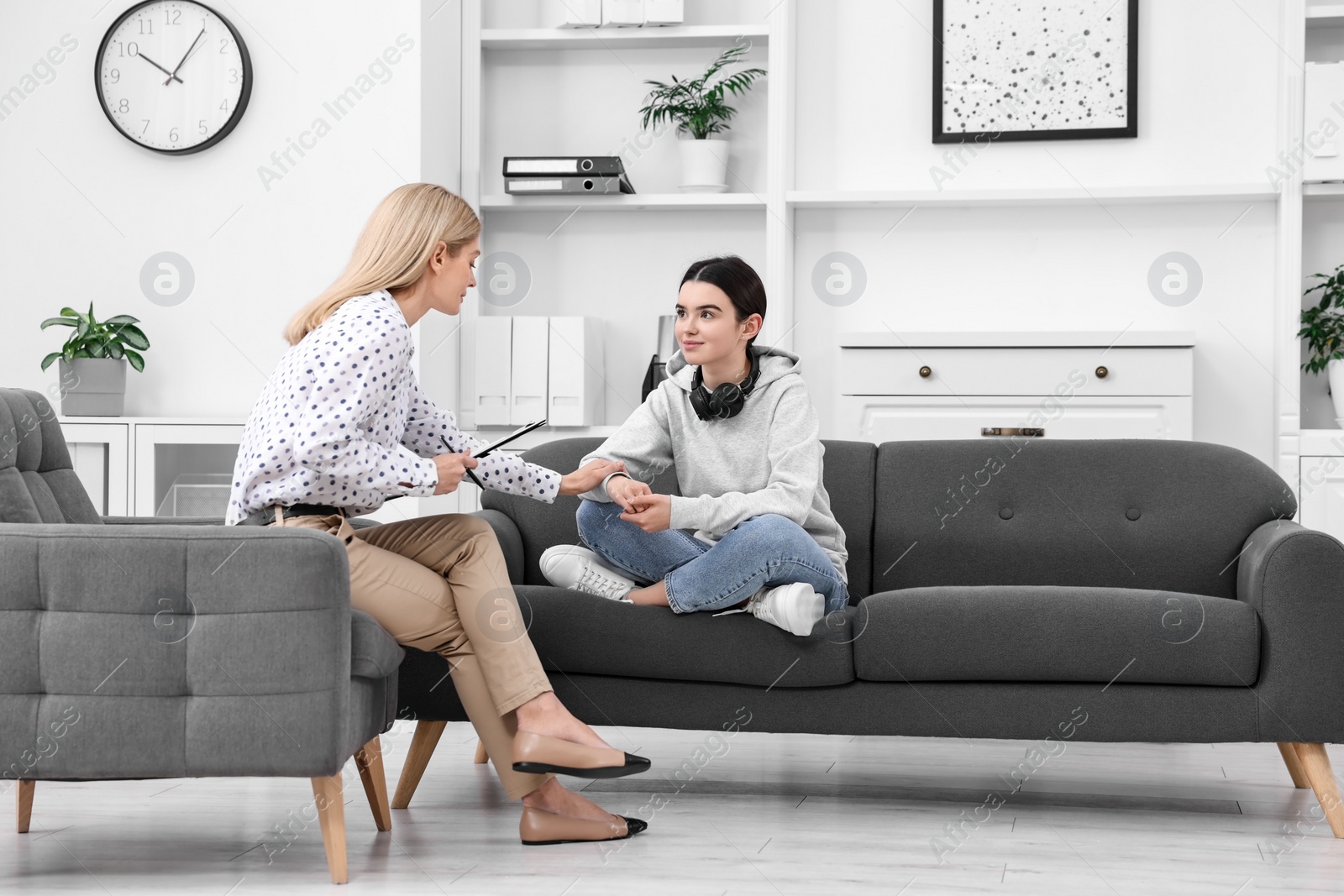 Photo of Psychologist working with teenage girl in office