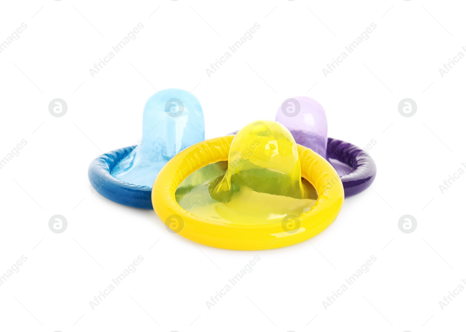 Photo of Unpacked colorful condoms on white background. Safe sex