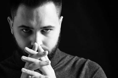 Photo of Portrait of handsome bearded man on dark background. Black and white effect