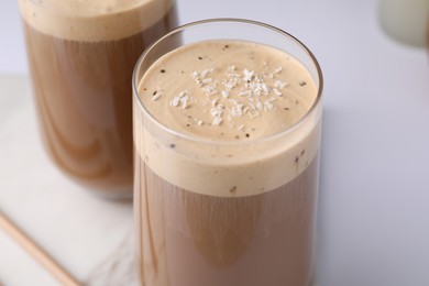 Photo of Delicious coffee with coconut syrup on white table, closeup