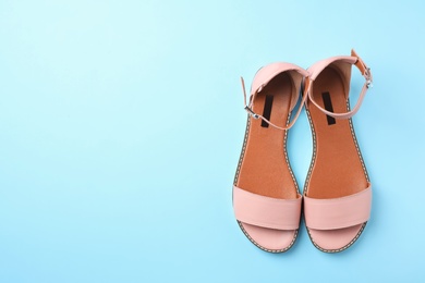 Photo of Pair of trendy women's shoes on color background, top view