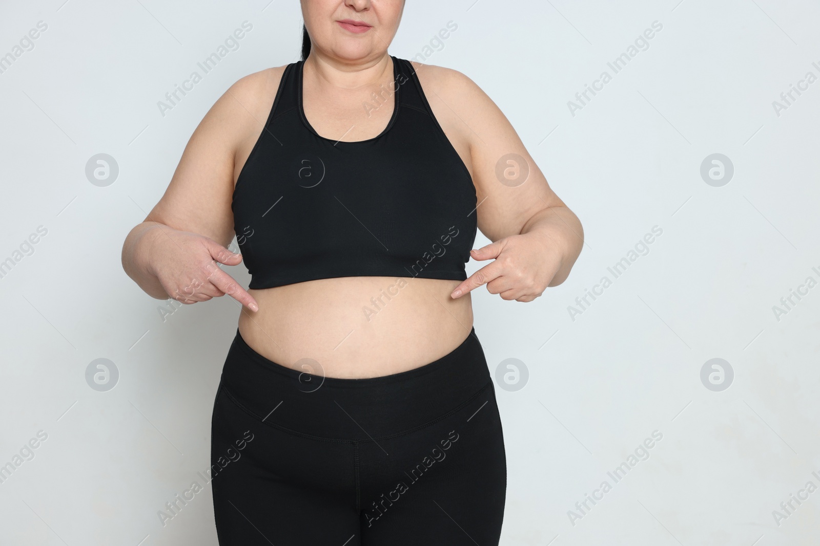 Photo of Obese woman on white background, closeup with space for text. Weight loss surgery