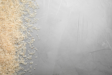 Photo of Rice on light grey table, top view. Space for text