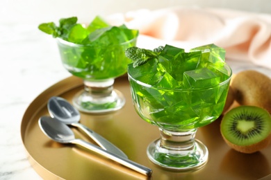 Photo of Composition with kiwi jelly in bowls on tray