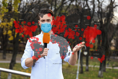 Image of Journalist with medical mask presenting news during coronavirus outbreak. World map demonstrating spread of disease