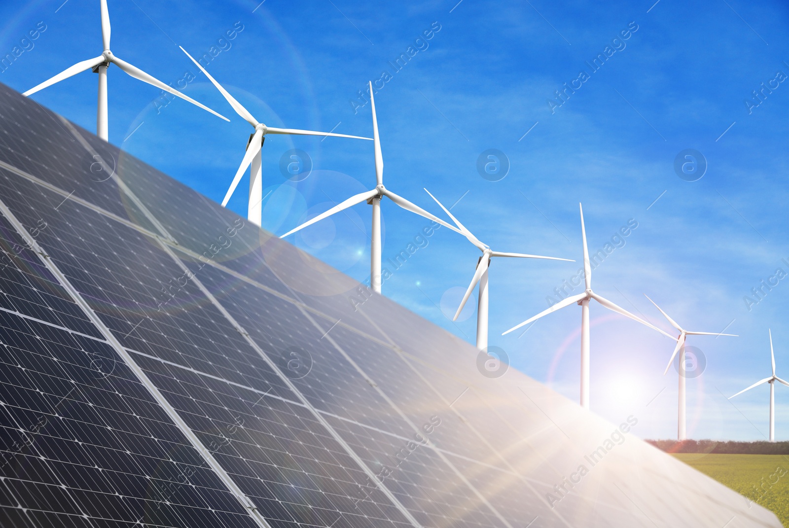 Image of Solar panels and wind turbines installed outdoors. Alternative energy source