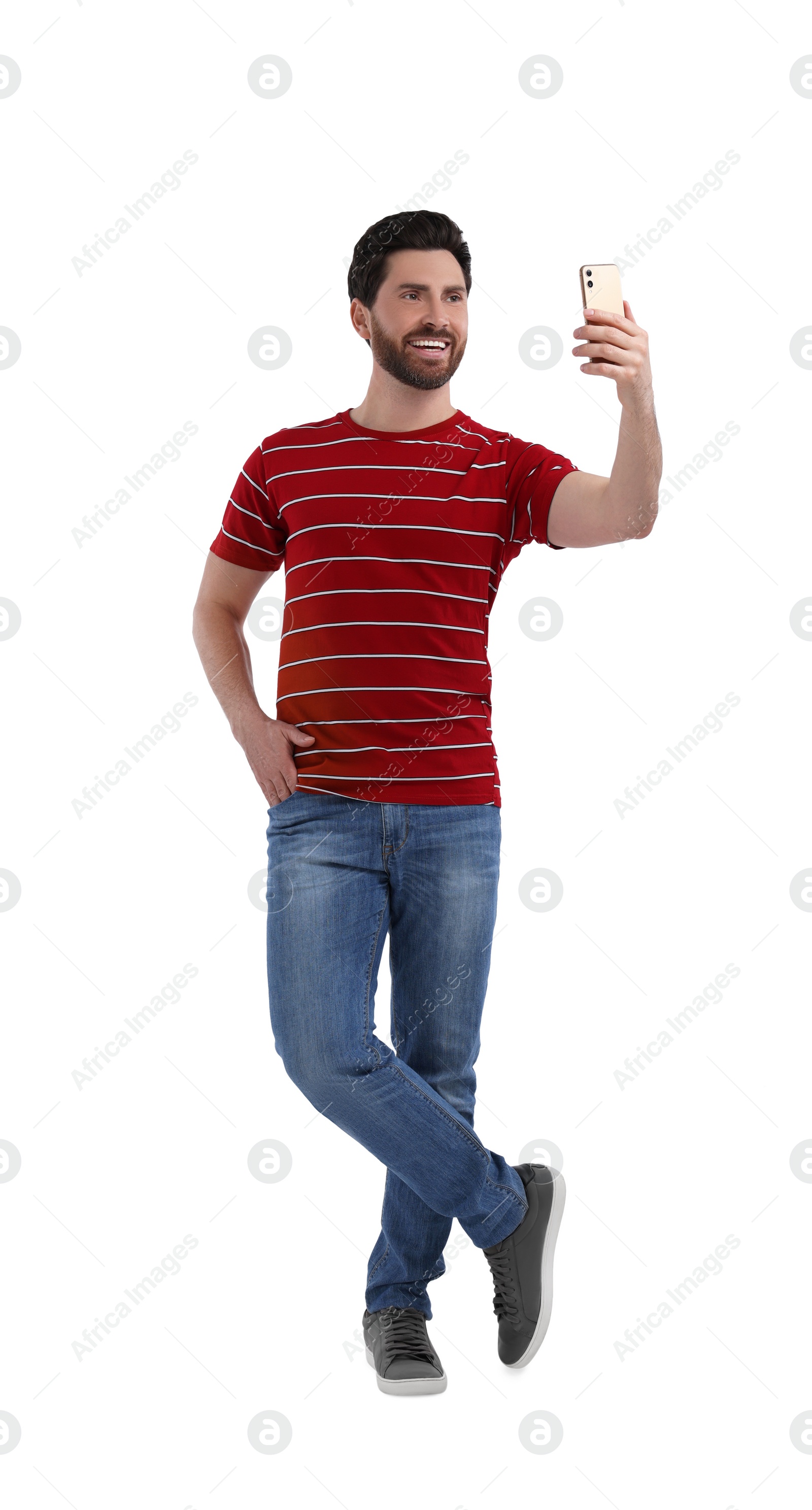 Photo of Smiling man taking selfie with smartphone on white background