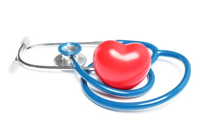 Stethoscope and heart model on light background. Medical equipment