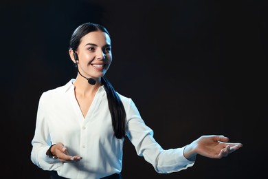 Photo of Motivational speaker with headset performing on stage. Space for text