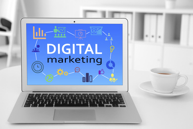 Image of Digital marketing concept. Modern laptop on white table