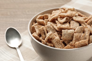 Photo of Bowl of sweet crispy breakfast cereal on table, closeup