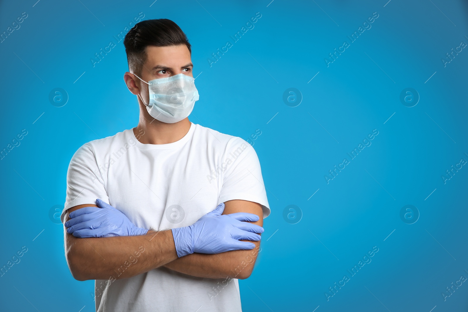 Photo of Man wearing protective face mask and medical gloves on blue background. Space for text