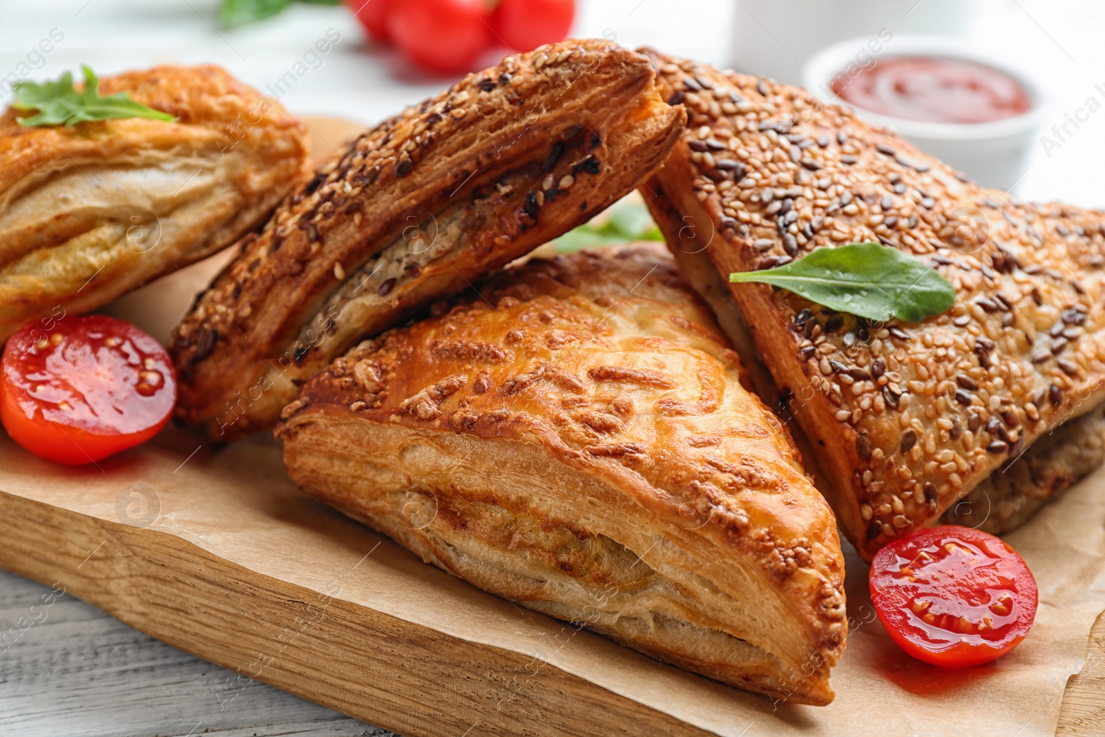 Photo of Fresh delicious puff pastry served on white wooden table, closeup