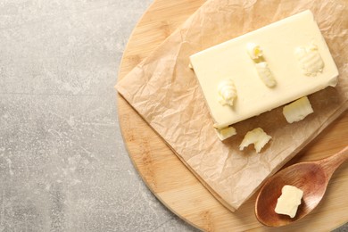 Photo of Tasty butter on grey table, top view. Space for text