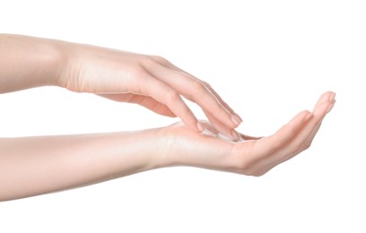 Woman applying cream on her hand against white background, closeup