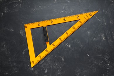 Photo of Triangle ruler with measuring length markings on blackboard, top view