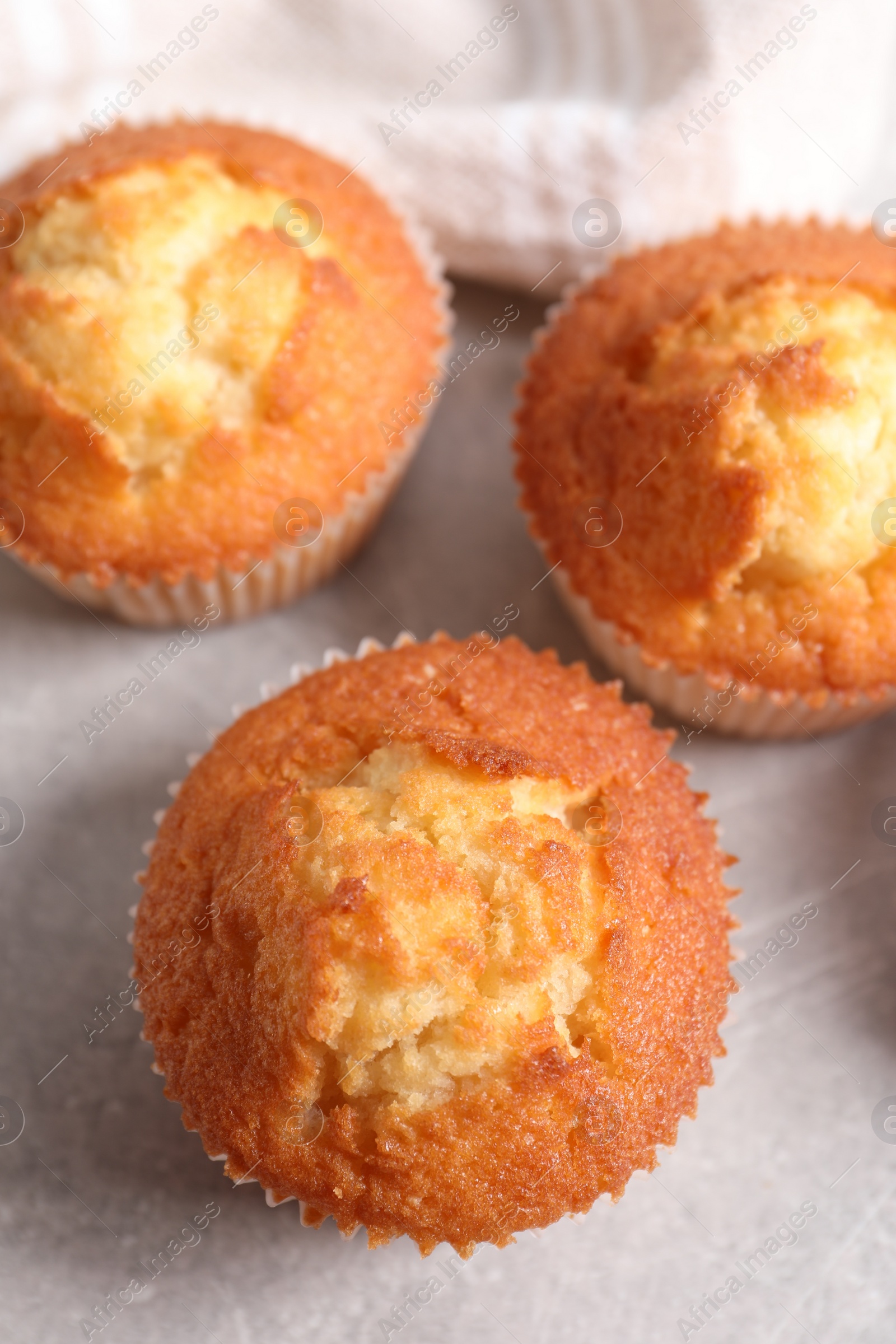 Photo of Tasty muffins on light grey table, flat lay. Fresh pastry