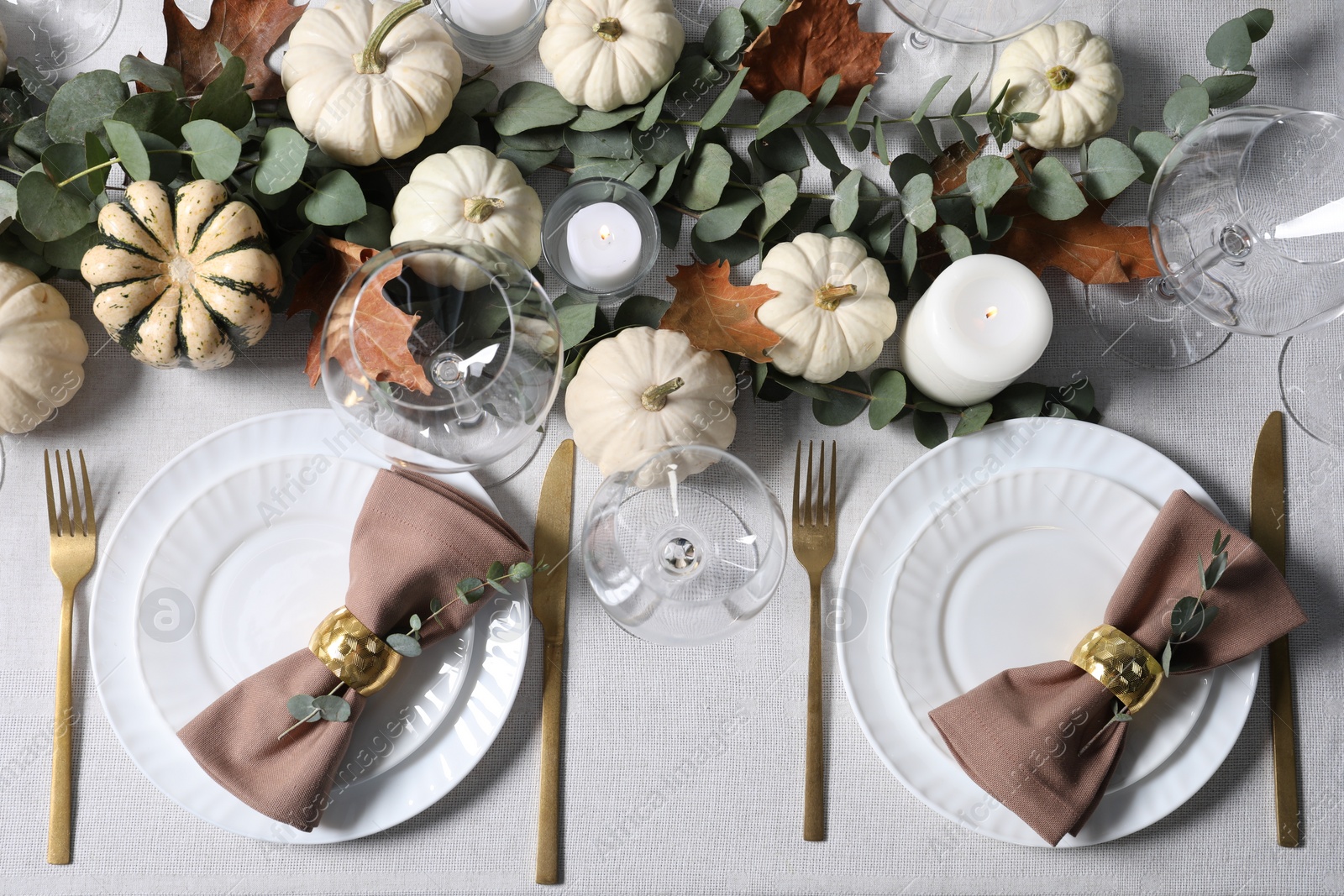 Photo of Beautiful autumn table setting. Plates, cutlery, glasses, pumpkins and floral decor, flat lay