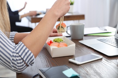 Photo of Office employee having lunch at workplace, closeup. Food delivery