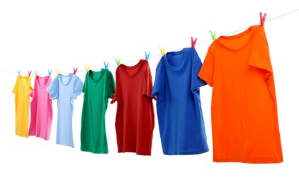 Photo of Colorful t-shirts drying on washing line isolated on white