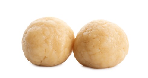Photo of Making shortcrust pastry. Raw dough balls isolated on white