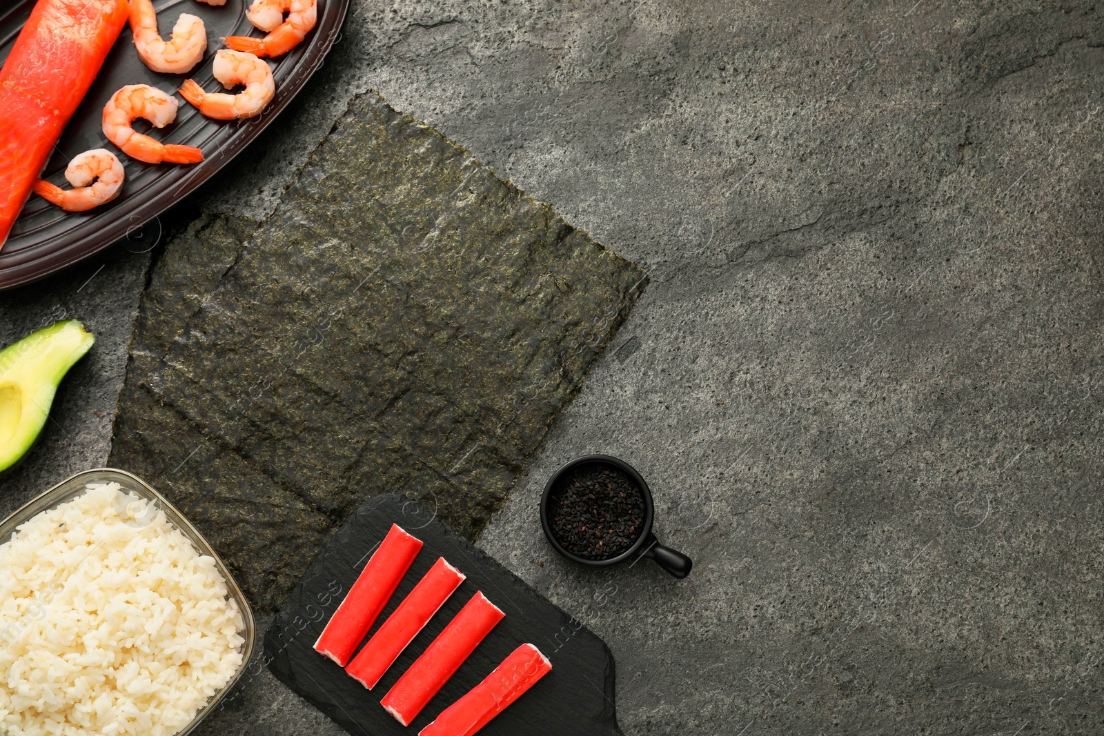 Photo of Flat lay composition with ingredients for sushi on dark textured table. Space for text