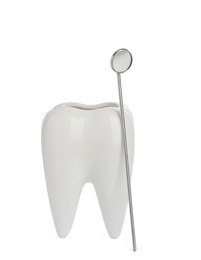 Photo of Tooth shaped holder and mouth mirror on white background