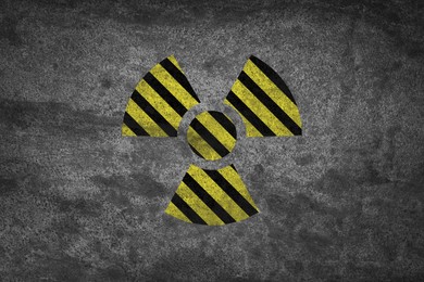 Image of Radioactive sign on grey stone wall. Hazard symbol