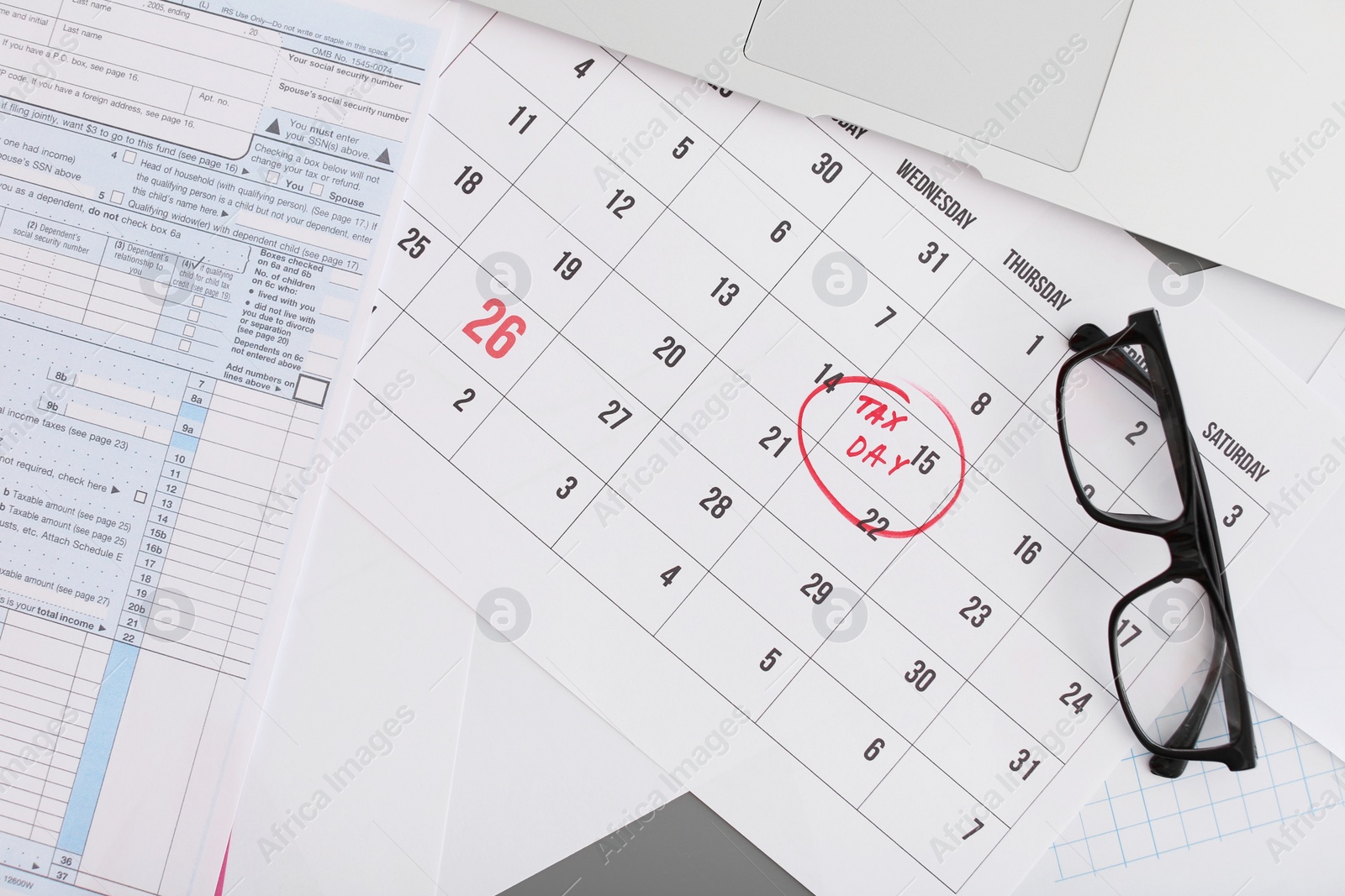 Photo of Flat lay composition with calendar, documents and glasses on table. Tax day