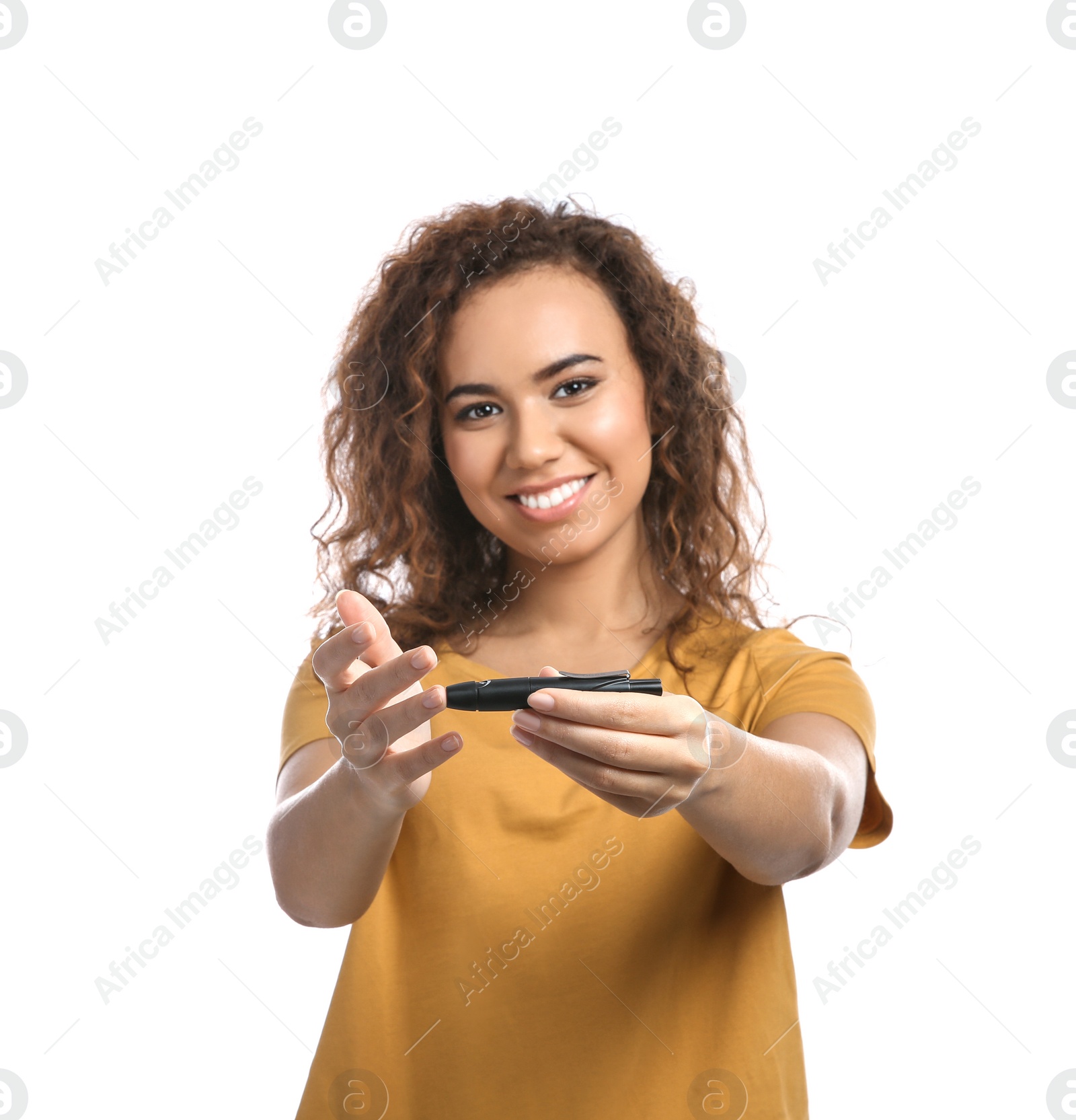 Photo of Young African-American woman using lancet pen on white background. Diabetes control