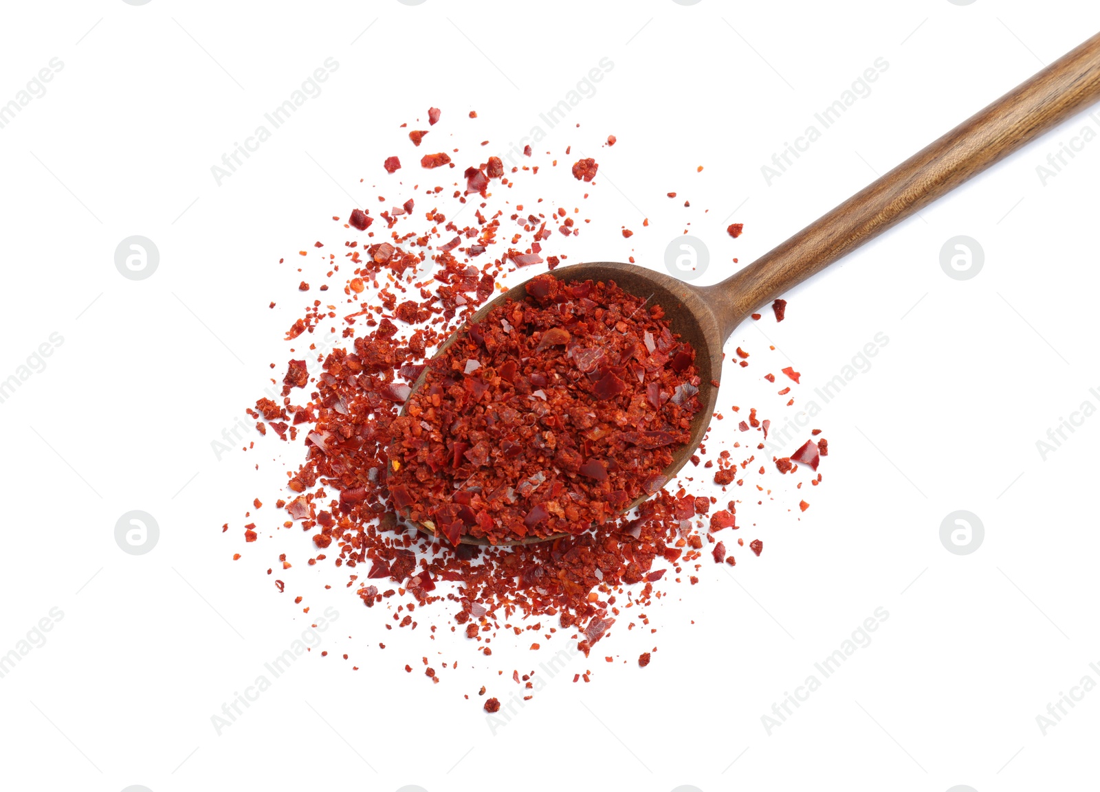 Photo of Spoon with crushed chili pepper on white background