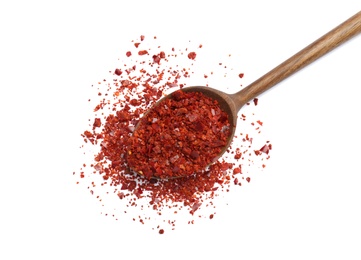 Spoon with crushed chili pepper on white background