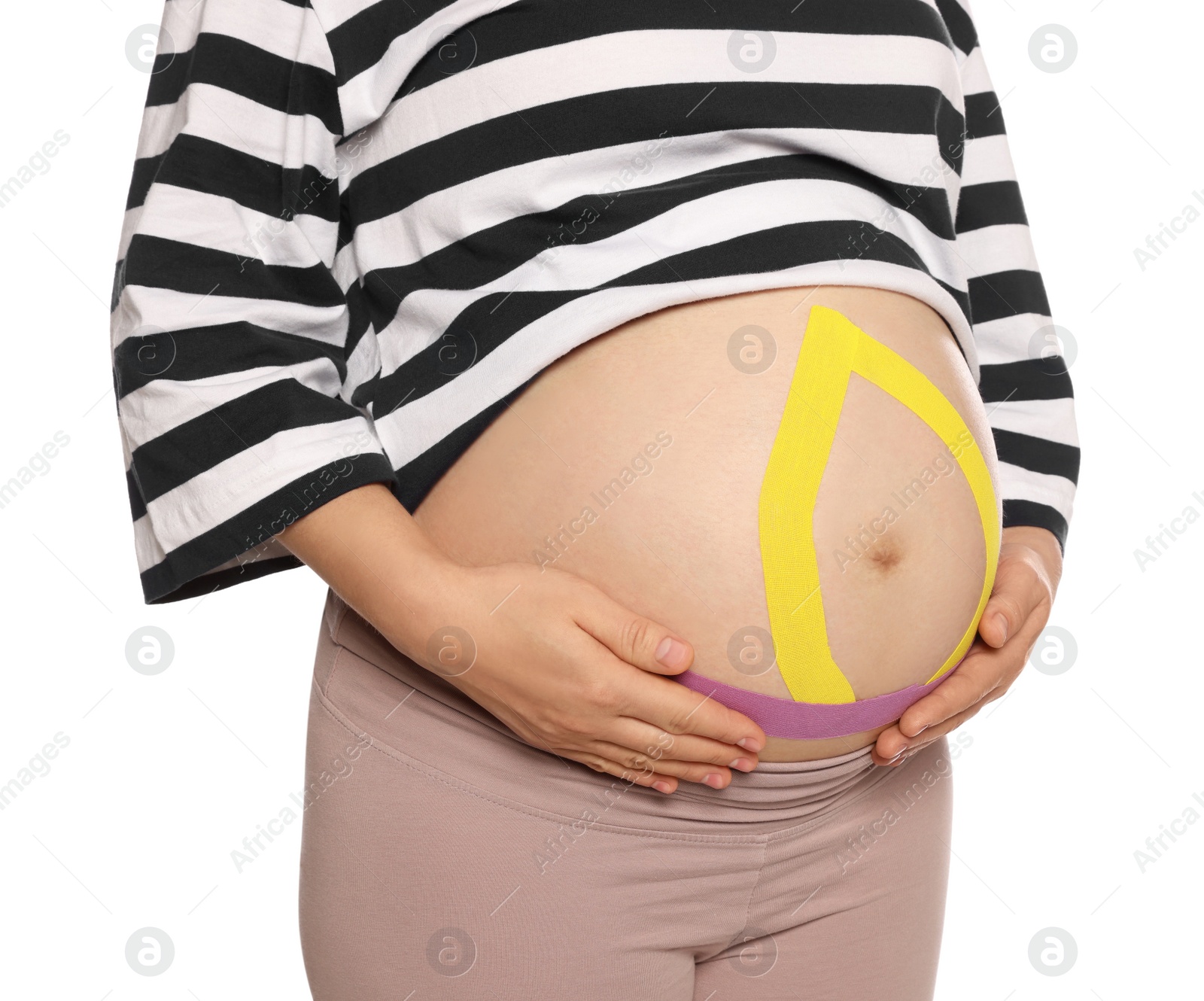 Photo of Pregnant woman with kinesio tapes on her belly against white background, closeup