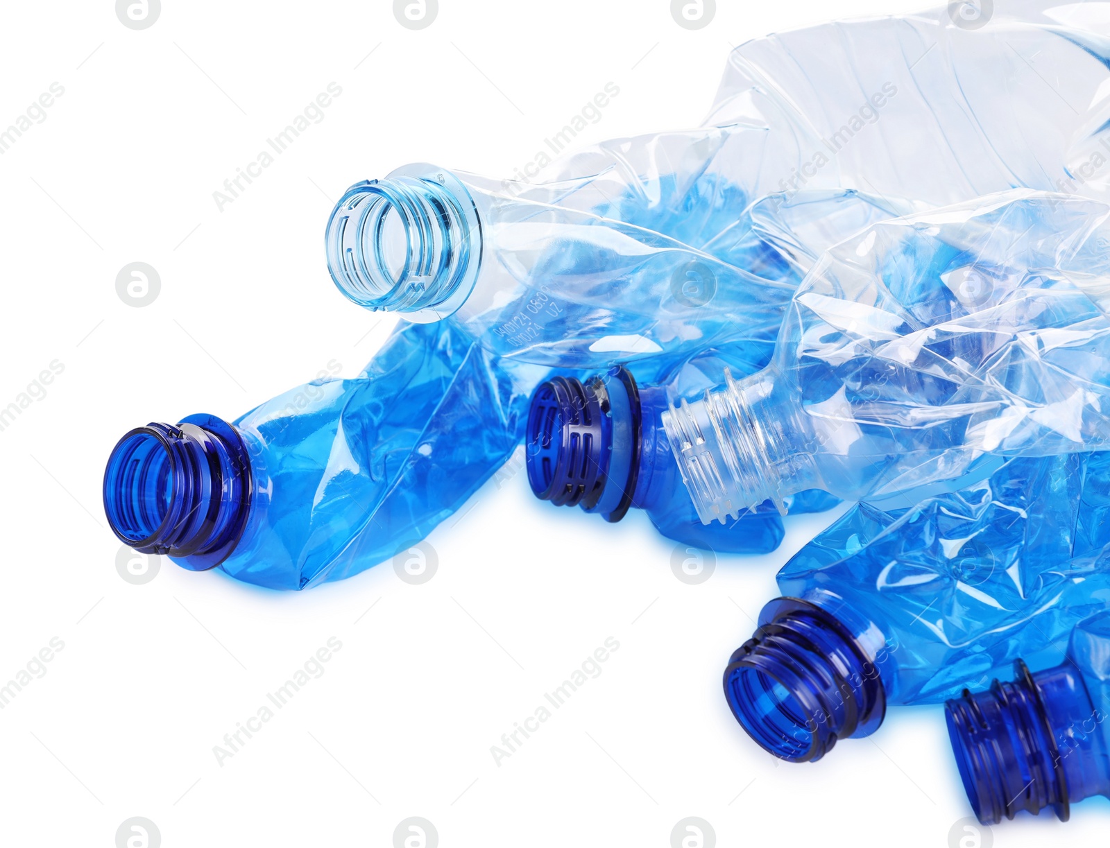 Photo of Crumpled disposable plastic bottles on white background