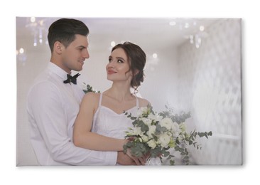 Photo printed on canvas, white background. Happy newlywed couple together in festive hall