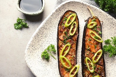 Plate with fried eggplant slices on table, top view