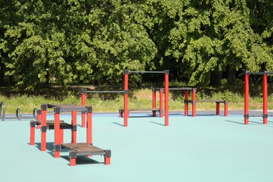 Photo of Empty outdoor gym with exercise equipment in park