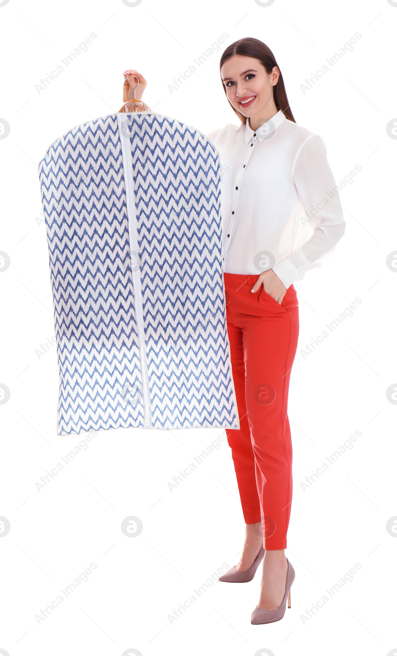 Photo of Young woman holding hanger with clothes in garment cover on white background. Dry-cleaning service