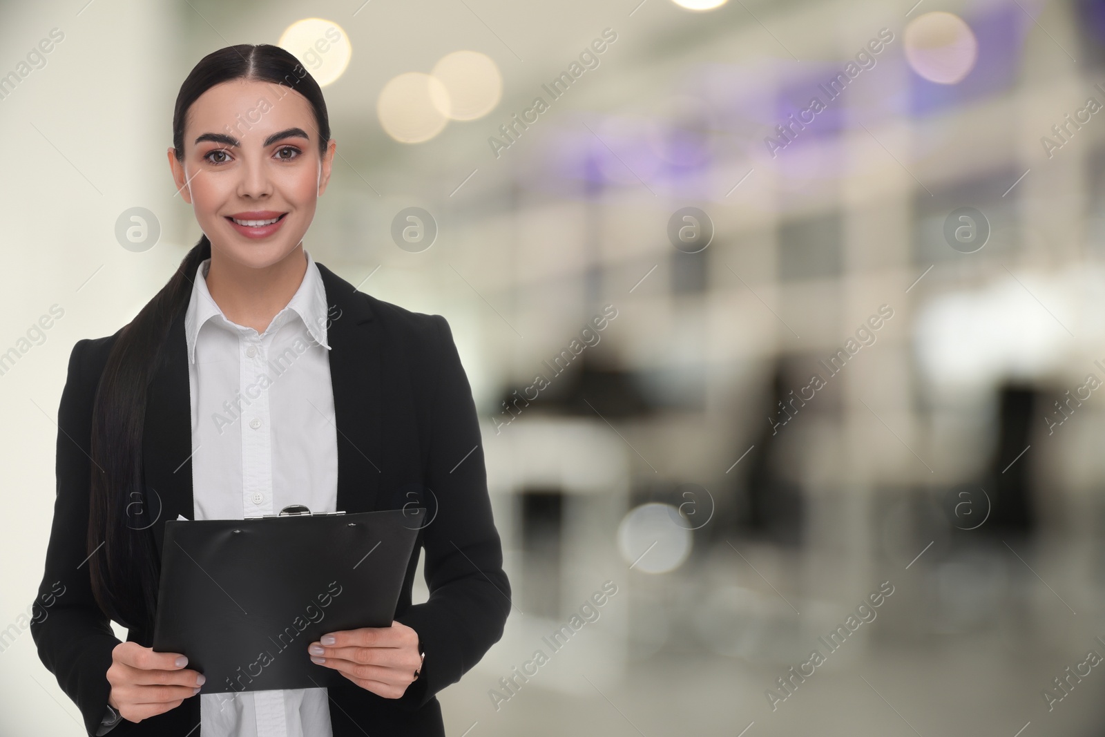 Image of Lawyer, consultant, business owner. Confident woman with clipboard smiling indoors, space for text