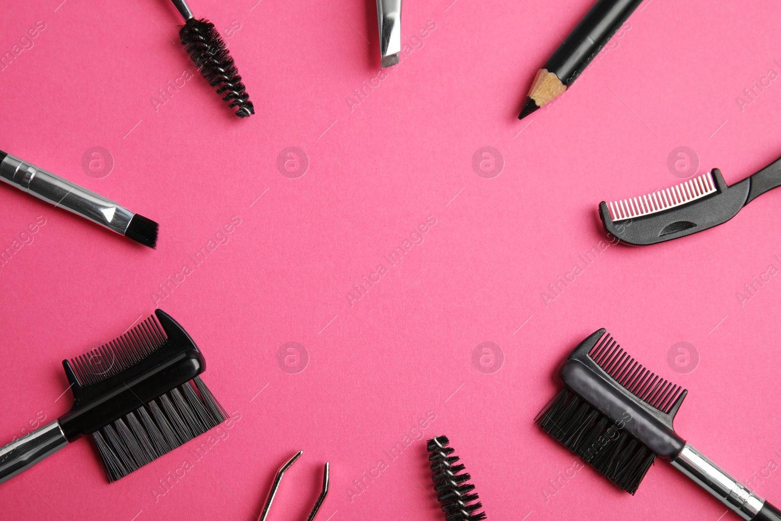 Photo of Set of professional eyebrow tools on pink background, flat lay. Space for text