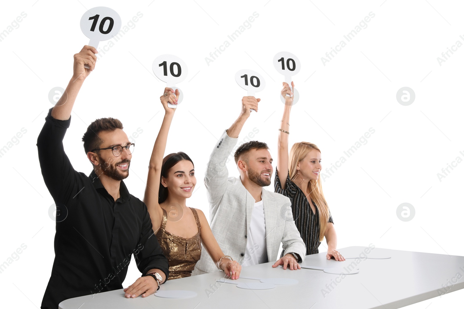 Photo of Panel of judges holding signs with highest score at table on white background