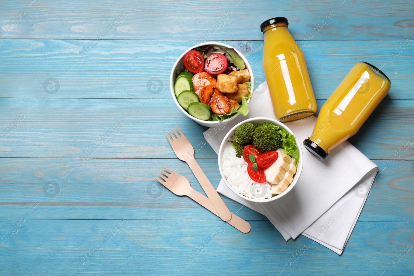 Photo of Flat lay composition with healthy takeaway food on light blue wooden table. Space for text