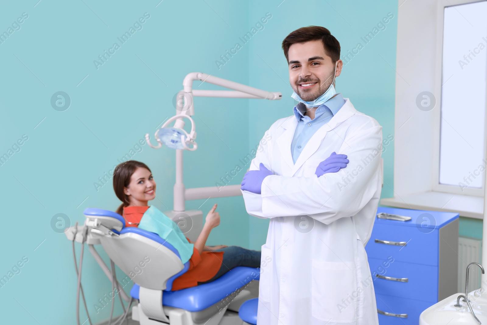 Photo of Professional dentist and patient in modern clinic