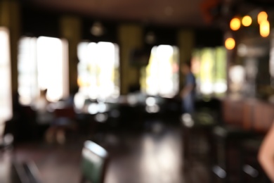 Blurred view of beer pub with stylish furniture