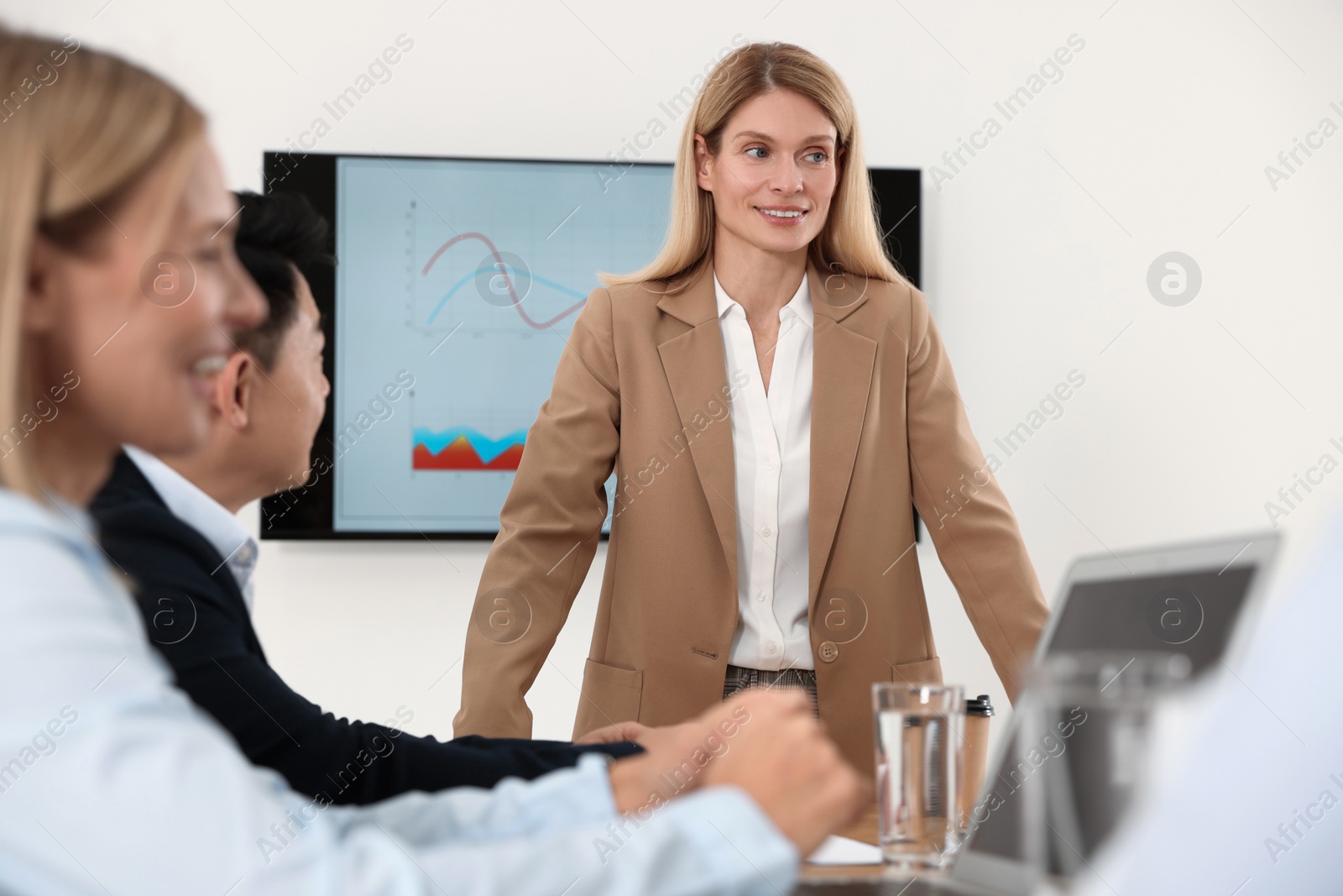 Photo of Businesswoman having meeting with her employees in office