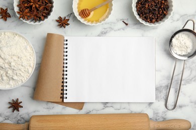 Blank recipe book, cooking utensils and ingredients on white marble table, flat lay. Space for text