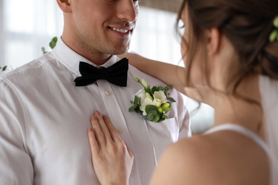 Photo of Happy newlywed couple dancing together indoors, closeup