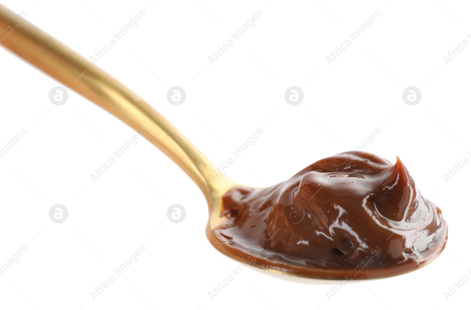 Photo of Spoon with tasty boiled condensed milk isolated on white